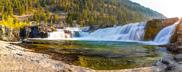 Vibrant View of Kootenai Falls Through Golden Sunlight
