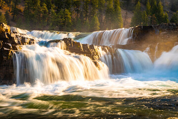 Vibrant View of Kootenai Falls Through Golden Sunlight