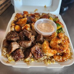 Assorted Grilled Meats, Shrimp, Vegetables, and Rice in Takeout Container with Sweet Sauce