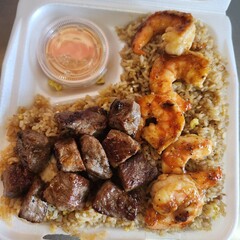 Assorted Grilled Meats, Shrimp, Vegetables, and Rice in Takeout Container with Sweet Sauce