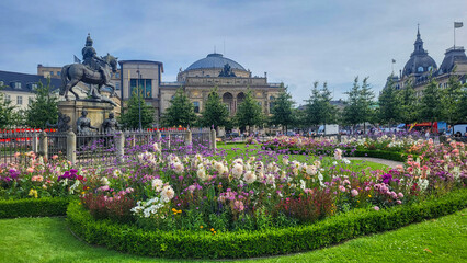 07 August, 2024, Copenhagen city center, Denmark Summer day scenic canal with boats and tourists, cyclists riding along colorful buildings and waterfront, vibrant urban atmosphere in European capital