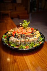 Delicious Sushi Platter with Fresh Salmon and Vegetables on a Wooden Table.