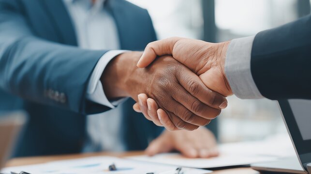 Investment banker shaking hands with a client