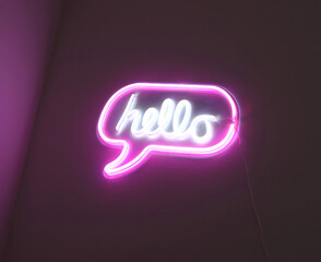 Pink neon sign displaying 'hello' in speech bubble
