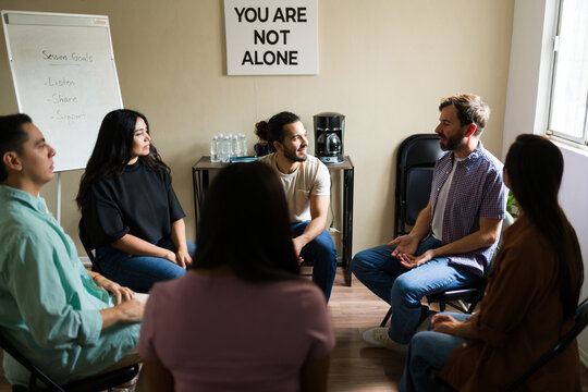 People sharing experiences during a support group therapy session - Powered by Adobe