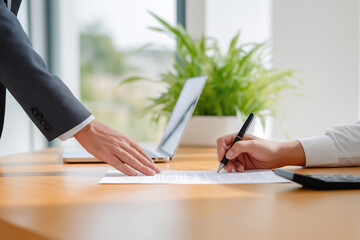 Client signs agreement in modern office setting during business meeting
