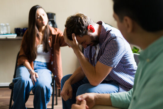 Man receiving support during group therapy session - Powered by Adobe