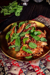 Golden Plate of Crispy Fried Food Garnished with Fresh Green Herbs.