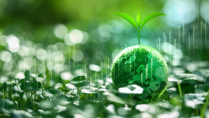 A plant growing on a green Earth with technology bar graphs. Concept of green finance and...