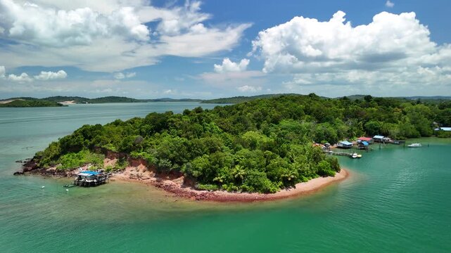 bintan islands blue lagoon also known as danau biru features striking turquoise waters surrounded by white sand hills creating a stunning contrast and serene tropical atmosphere