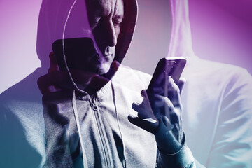 Double exposure of man in hoodie using smartphone, creative concept symbolizing technology, connection, and digital identity.