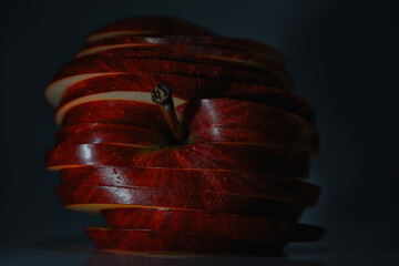 crisp layered fruit composition, closeup of glossy apple slices under dramatic light
