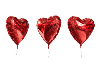 Three shiny, heart-shaped red foil balloons on a solid black background, isolated