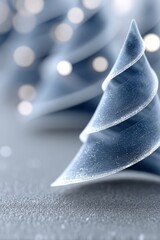 Minimal abstract glass Christmas tree on soft blue background with bokeh lights and copy space, modern holiday concept