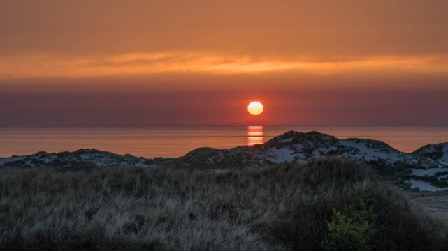 Amrum, Germany: Beautiful sunset at beach and dunes of Amrum island, 4k, time lapse