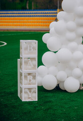 Transparent boxes with balloons and Baby sign for gender reveal party