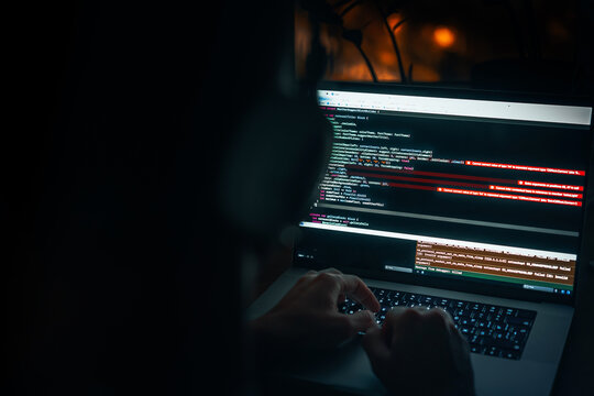 Programmer's hands are coding on a laptop in the dark with a view of the lights of the night city. The concept of a developer or hacker. Saint Petersburg, Russia - 23 Oct 2025