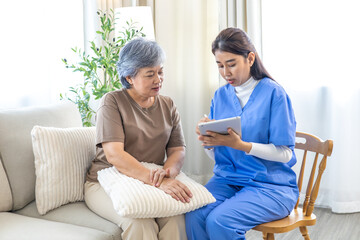 Obraz premium Asian senior elderly woman consulting with caregiver nurse female, discuss healthcare plan using digital tablet, focusing on medical advice, treatment progress, and patient wellness, at nursing home