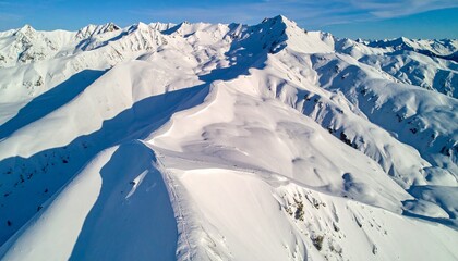 Aerial drone shot of snow-covered mountain patterns forming fractal geometry