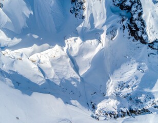 Aerial drone shot of snow-covered mountain patterns forming fractal geometry