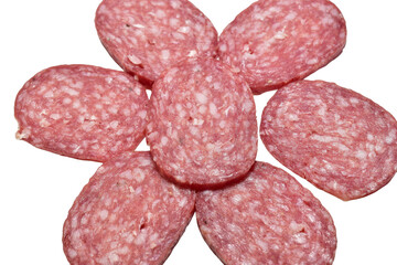 Dry-cured pork sausage cut into thin slices lies on a PNG background.