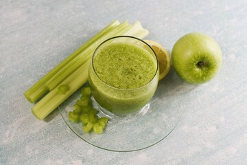 Smoothie made with celery sticks green apple lemon juice and pulp.