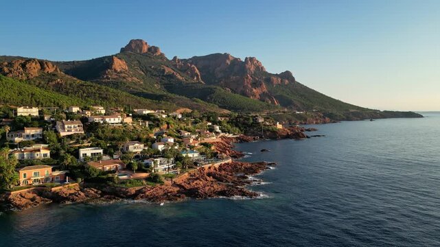 Aerial panoramic view of the Esterel Mountains near Saint Raphael, French Riviera, showing the Mediterranean Sea and luxury villas along the Cote dAzur coastline in the warm sunrise light
