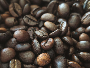 extreme close-up of roasted coffee beans showing rich texture and color with shallow depth of field