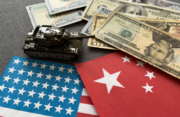Fototapeta premium Vietnamese dong currency money bills and toy tank on flag close up. The concept of army funds and weapons sales