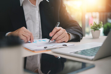 Businessman hand pen check financial document, data chart graph. Work office desk, laptop. Business finance accounting concept, analysis report, budget planning, investment audit, corporate executive.