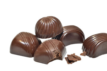 Chocolate candies with fillings of different shapes lie on a PNG background.