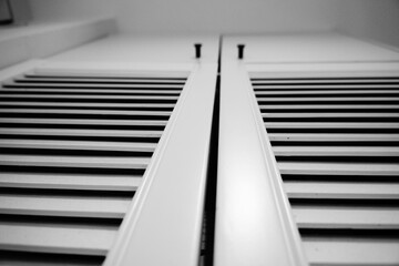 Close-up View of White Louvered Shutters Against a White Wall, Minimalist Interior Design
