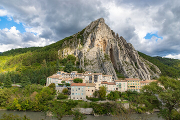 Picturesque town nestled beneath a dramatic mountain cliff. Sisteron, France