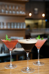 Three Elegant Cocktails in Martini Glasses