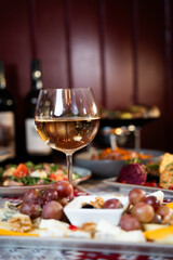 Glass of White Wine with Cheese and Grapes