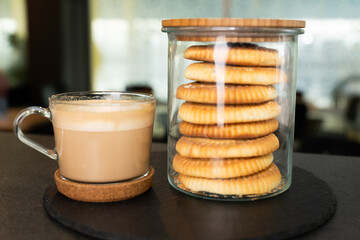 Cup of Latte with Cookies in Jars