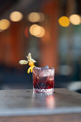 Red cocktail with garnish in glass