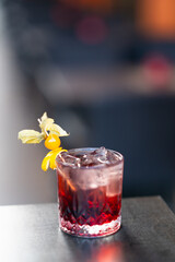 Red cocktail with garnish in glass
