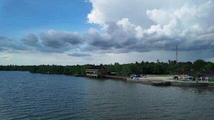 bintan islands blue lagoon also known as danau biru features striking turquoise waters surrounded by white sand hills creating a stunning contrast and serene tropical atmosphere