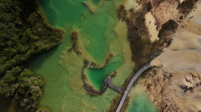 bintan islands blue lagoon also known as danau biru features striking turquoise waters surrounded by white sand hills creating a stunning contrast and serene tropical atmosphere
