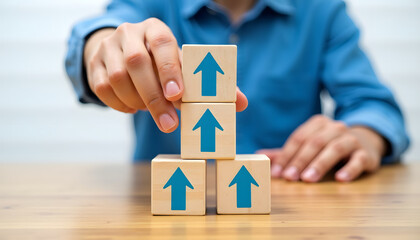 Person arranging wooden blocks with upward-pointing arrows, symbolizing growth and progress