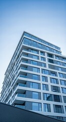 Modern building rises against clear sky in urban cityscape