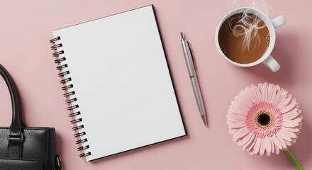 Overhead view of a blank spiral notebook, pen, coffee cup, and flower on a pink background