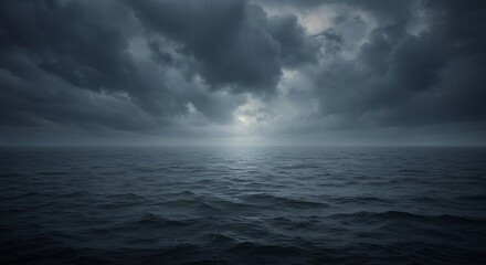 Obraz premium Dark, heavy clouds hang over a rough ocean surface with a subtle glint of light breaking through. Moody sea scene for background or conceptual design.