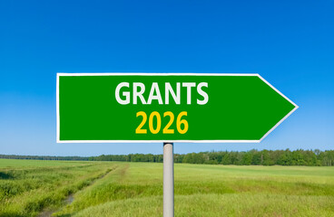 Grants 2026 symbol. Concept words Grants 2026 on beautiful green road sign. Beautiful green grass field forest and blue sky background. Business and grants 2026 concept. Copy space.