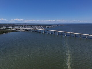 Aerial View Of Washington Baum Bridge Over Calm Water of Roanoke Sound Connecting Roanoke Island to Nags Head on the Outer Banks. Bright blue sky, tranquil water, urban-seaside scene.