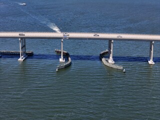 Aerial View Of Washington Baum Bridge Over Calm Water of Roanoke Sound Connecting Roanoke Island to Nags Head on the Outer Banks. Bright blue sky, tranquil water, urban-seaside scene.