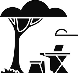 Silhouette of a person working on a laptop under a tree outdoors computer