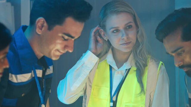 Diverse engineer team meeting and brainstorming work at night in the office. Corporate teamwork reviewing data and solving problem. Team discussing and sharing idea. Security and technology