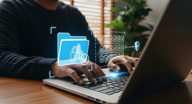 Person using a laptop with a digital overlay of a locked folder and data security icons, representing cybersecurity and data protection
